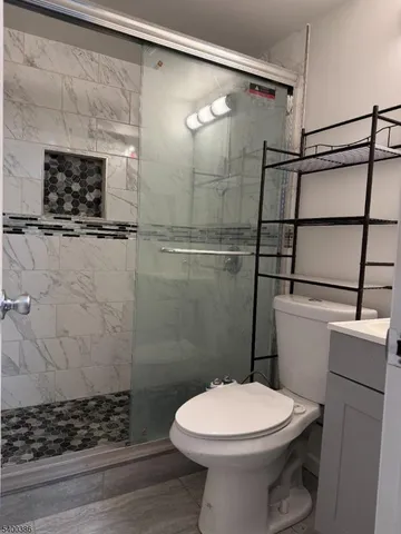 a bathroom with a toilet and a shower