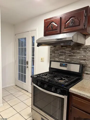 a stove top oven sitting inside of a kitchen
