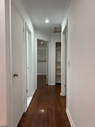 a view of hallway with wooden floor