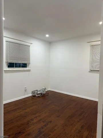 a view of a room with wooden floor and cabinet