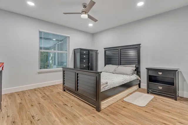 a bed room with a bed and a large window