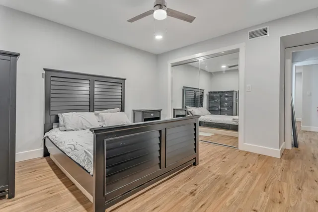 a bed room with a bed and a large window