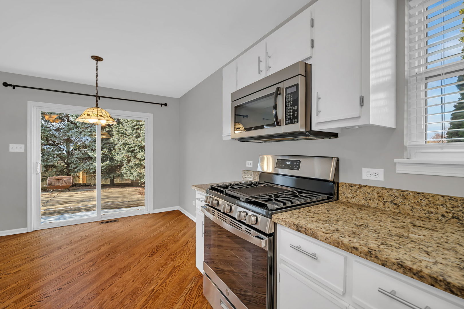 1211 Bluejay Lane Plainfield, IL 60586 - Photo 11 of 32 a kitchen with granite countertop cabinets stainless steel appliances and wooden floor