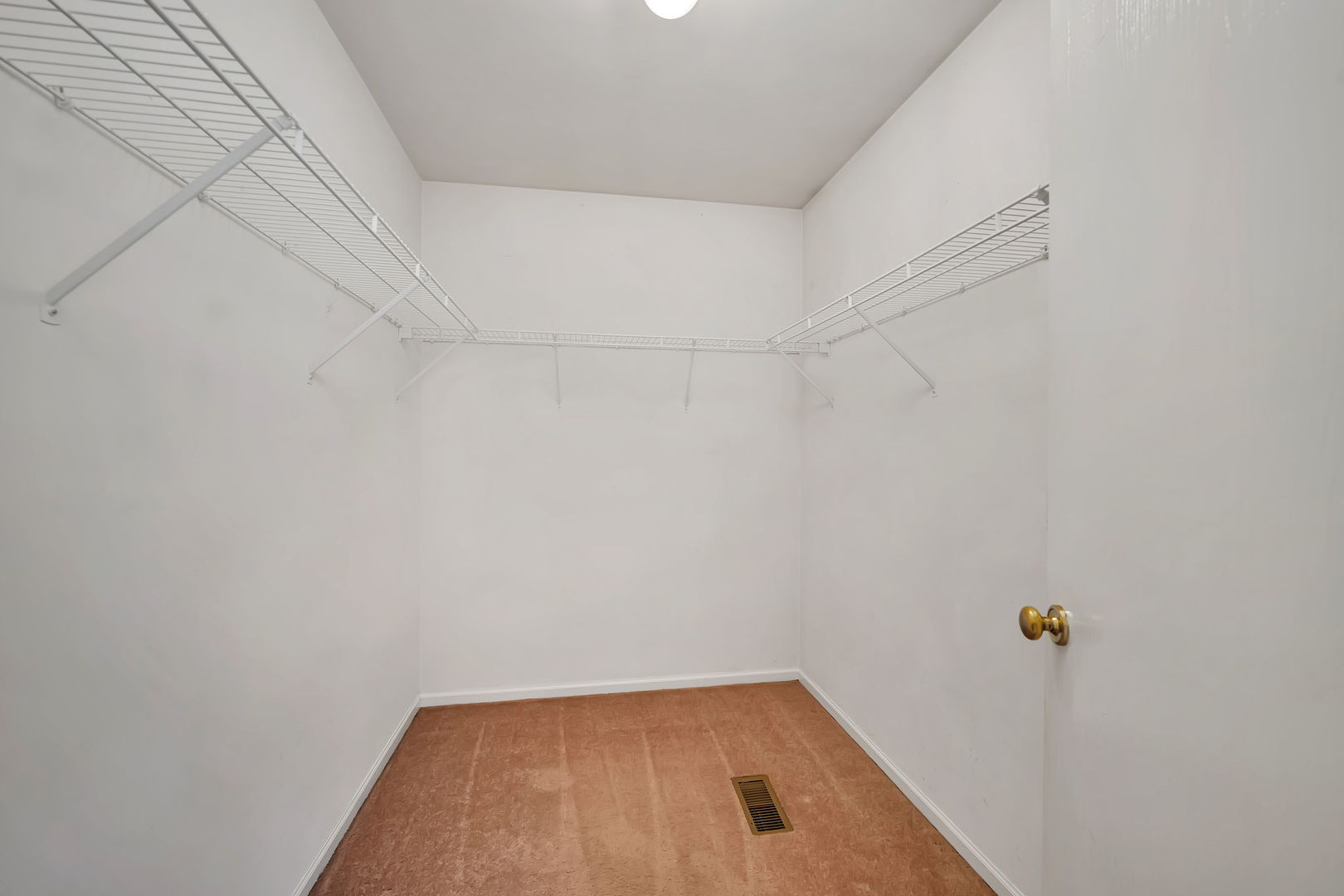 1211 Bluejay Lane Plainfield, IL 60586 - Photo 20 of 32 a view of a room with racks on the wall