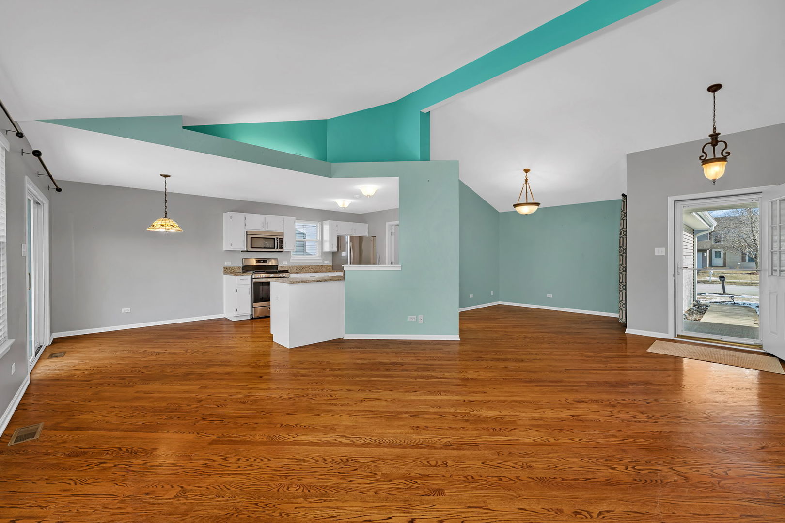 1211 Bluejay Lane Plainfield, IL 60586 - Photo 6 of 32 a view of a kitchen with kitchen island a sink wooden floor and a refrigerator
