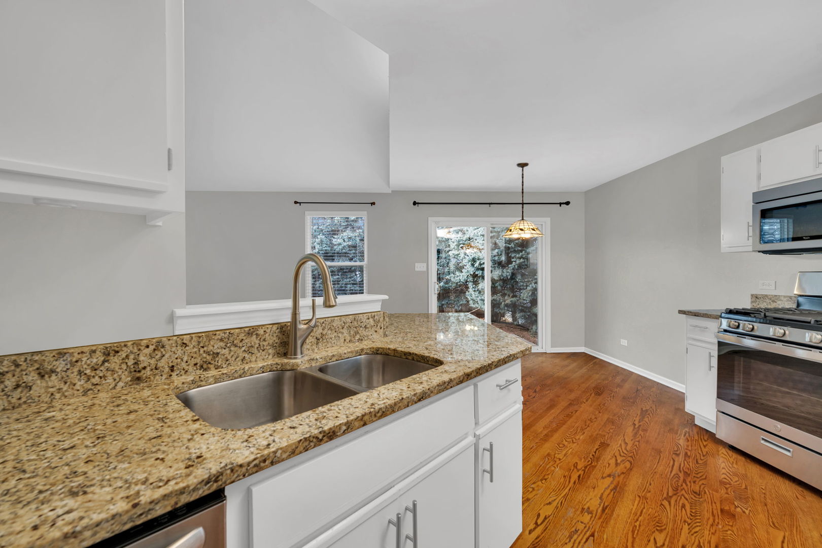 1211 Bluejay Lane Plainfield, IL 60586 - Photo 10 of 32 a kitchen with granite countertop a sink and a stove top oven