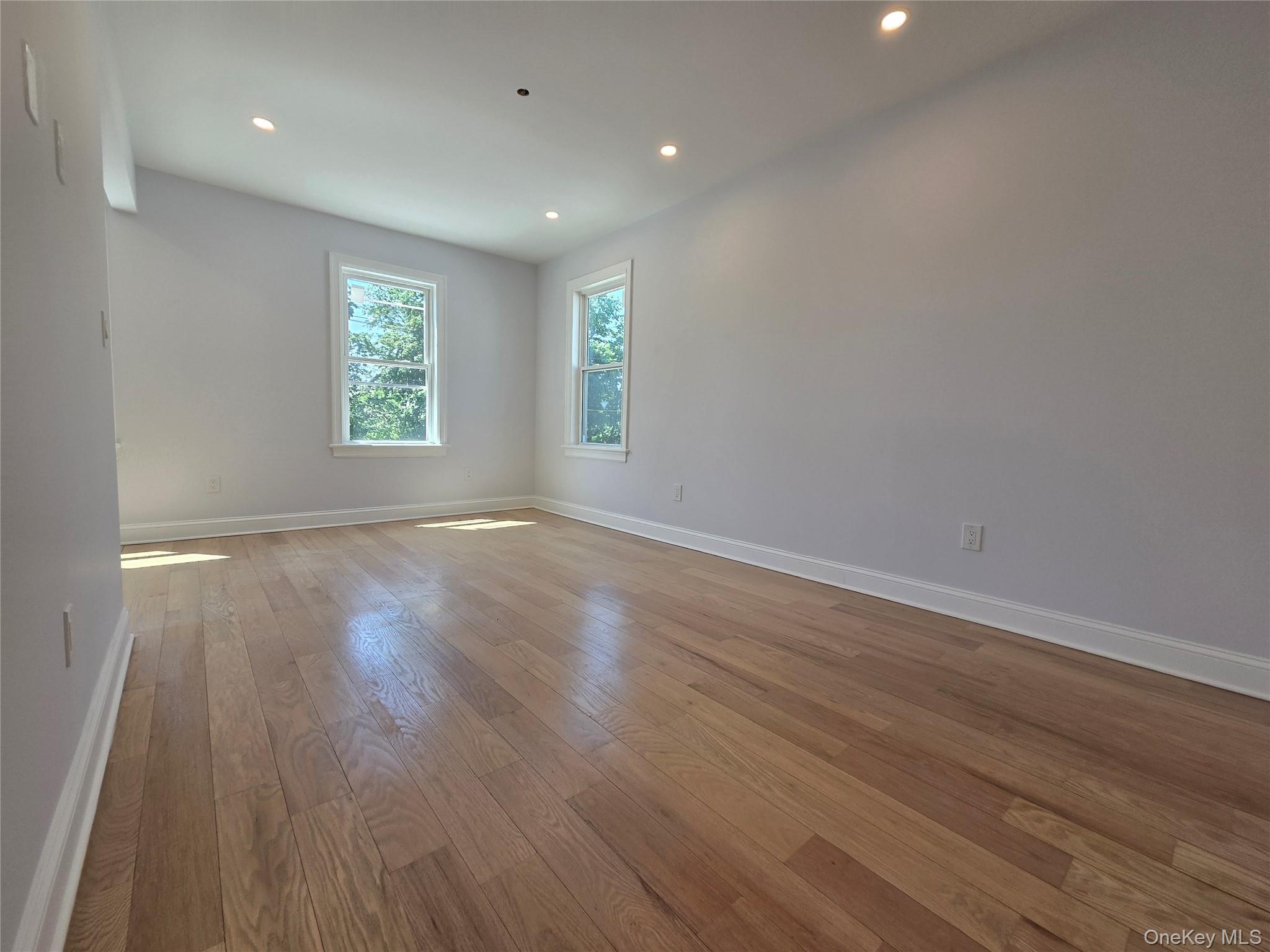 965 Main Street, Unit 2 New Rochelle, NY 10801 - Photo 5 of 12 Spacious interior room featuring wood-finish flooring, recessed lighting, and multiple windows