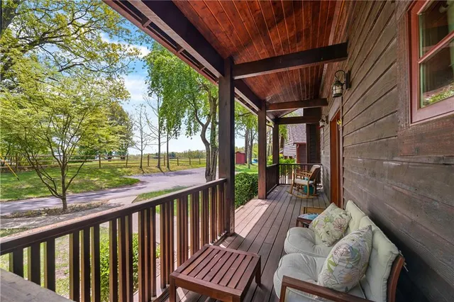 a view of porch with furniture and trees