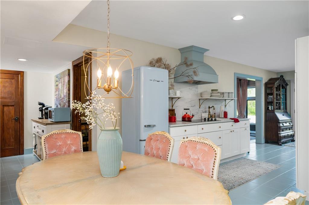 311 Derry Ridge Road Ligonier, PA 15658 - Photo 31 of 39 a kitchen with a refrigerator and chandelier