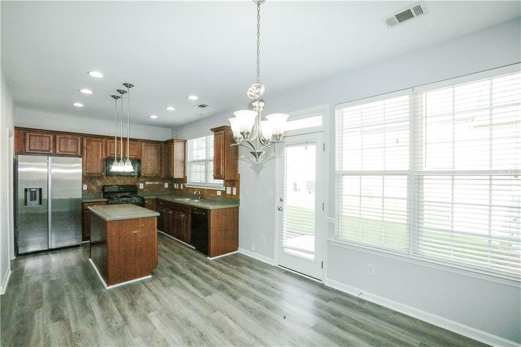 2410 Sardis Chase Court Buford, GA 30519 - Photo 13 of 35 a kitchen with a refrigerator and a stove top oven