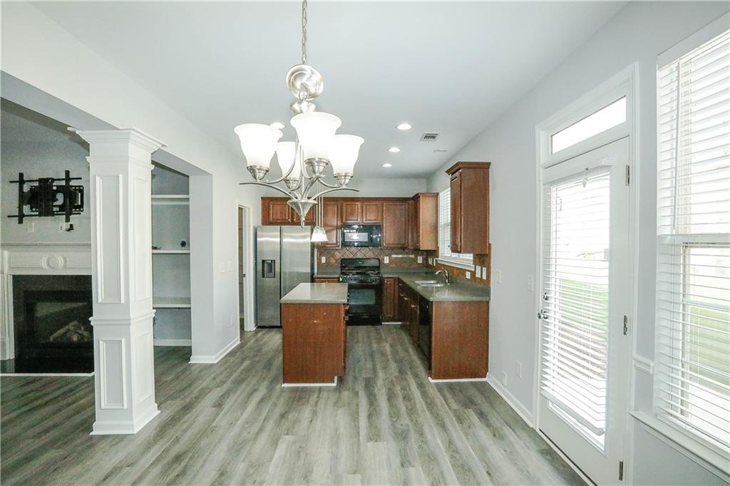 2410 Sardis Chase Court Buford, GA 30519 - Photo 14 of 35 a kitchen with stainless steel appliances granite countertop a refrigerator a oven a sink dishwasher and white cabinets with wooden floor