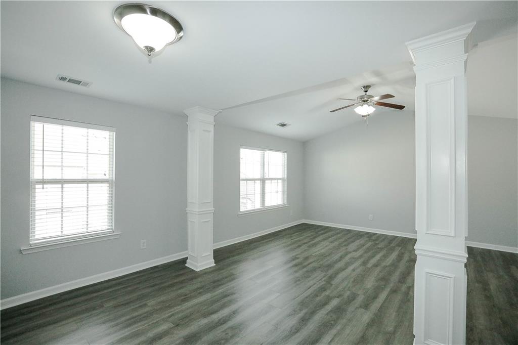2410 Sardis Chase Court Buford, GA 30519 - Photo 16 of 35 an empty room with wooden floor and windows