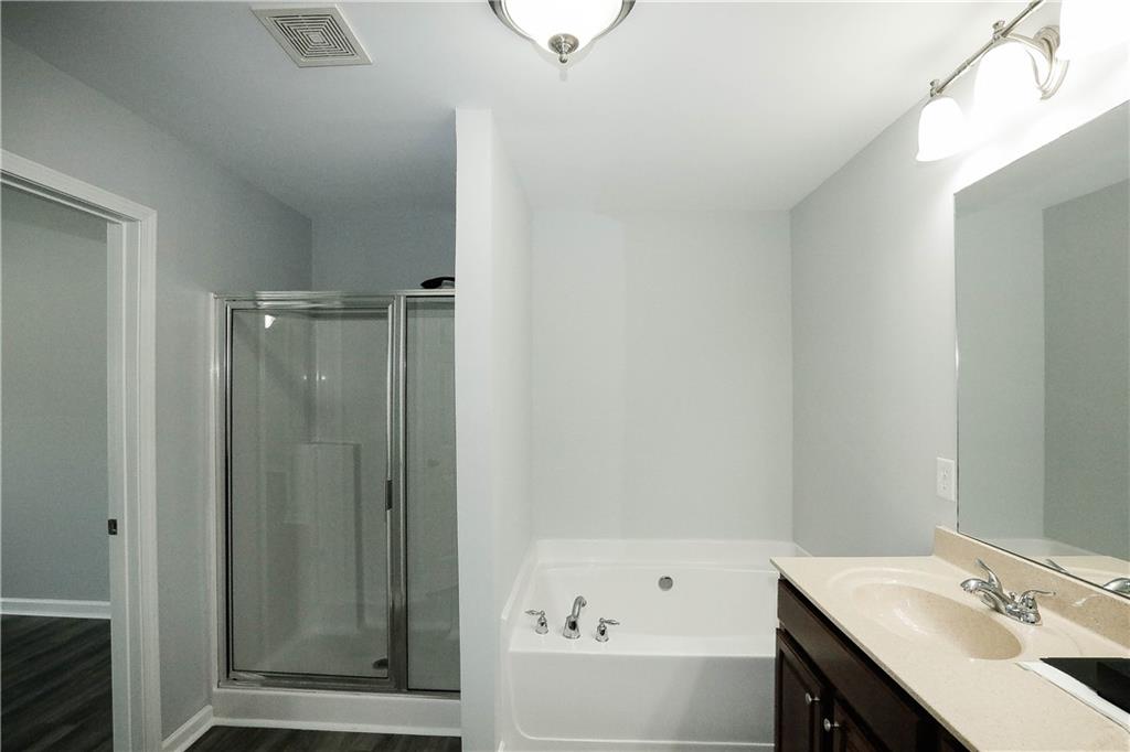 2410 Sardis Chase Court Buford, GA 30519 - Photo 22 of 35 a bathroom with a bathtub and a sink