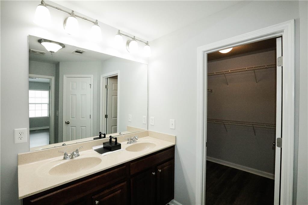 2410 Sardis Chase Court Buford, GA 30519 - Photo 23 of 35 a bathroom with a sink vanity and mirror