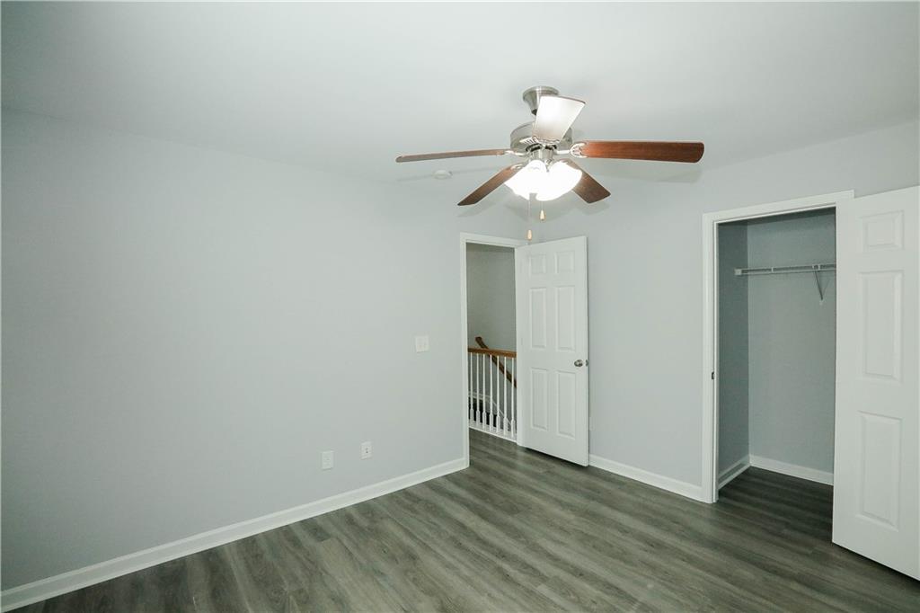 2410 Sardis Chase Court Buford, GA 30519 - Photo 25 of 35 a view of a room with wooden floor and a ceiling fan