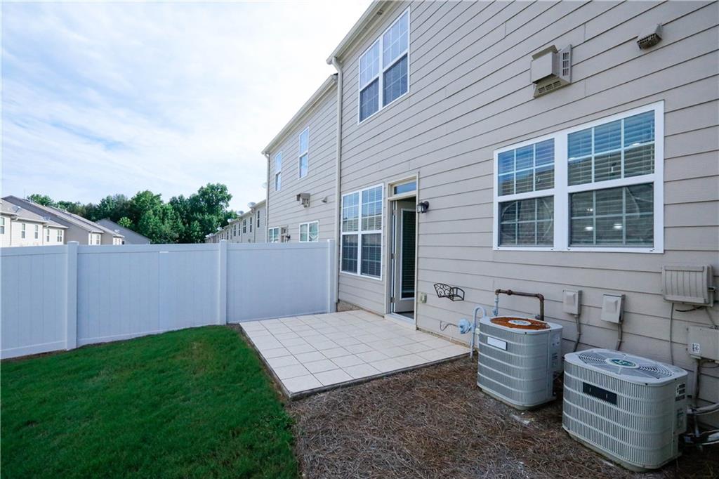 2410 Sardis Chase Court Buford, GA 30519 - Photo 29 of 35 a backyard of a house with fire pit and barbeque oven