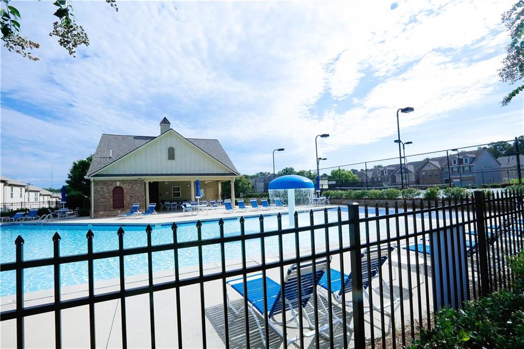 2410 Sardis Chase Court Buford, GA 30519 - Photo 32 of 35 a view of a brick house with a wooden fence