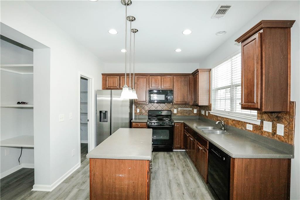 2410 Sardis Chase Court Buford, GA 30519 - Photo 8 of 35 a kitchen with stainless steel appliances granite countertop a sink stove and refrigerator