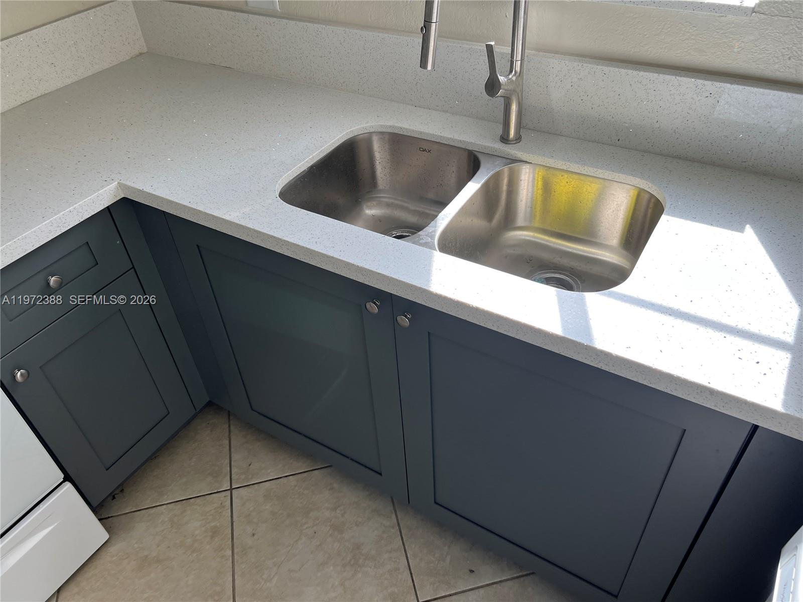 100 Southwest 15th Avenue Homestead, FL 33030 - Photo 11 of 62 a kitchen with a sink and cabinets