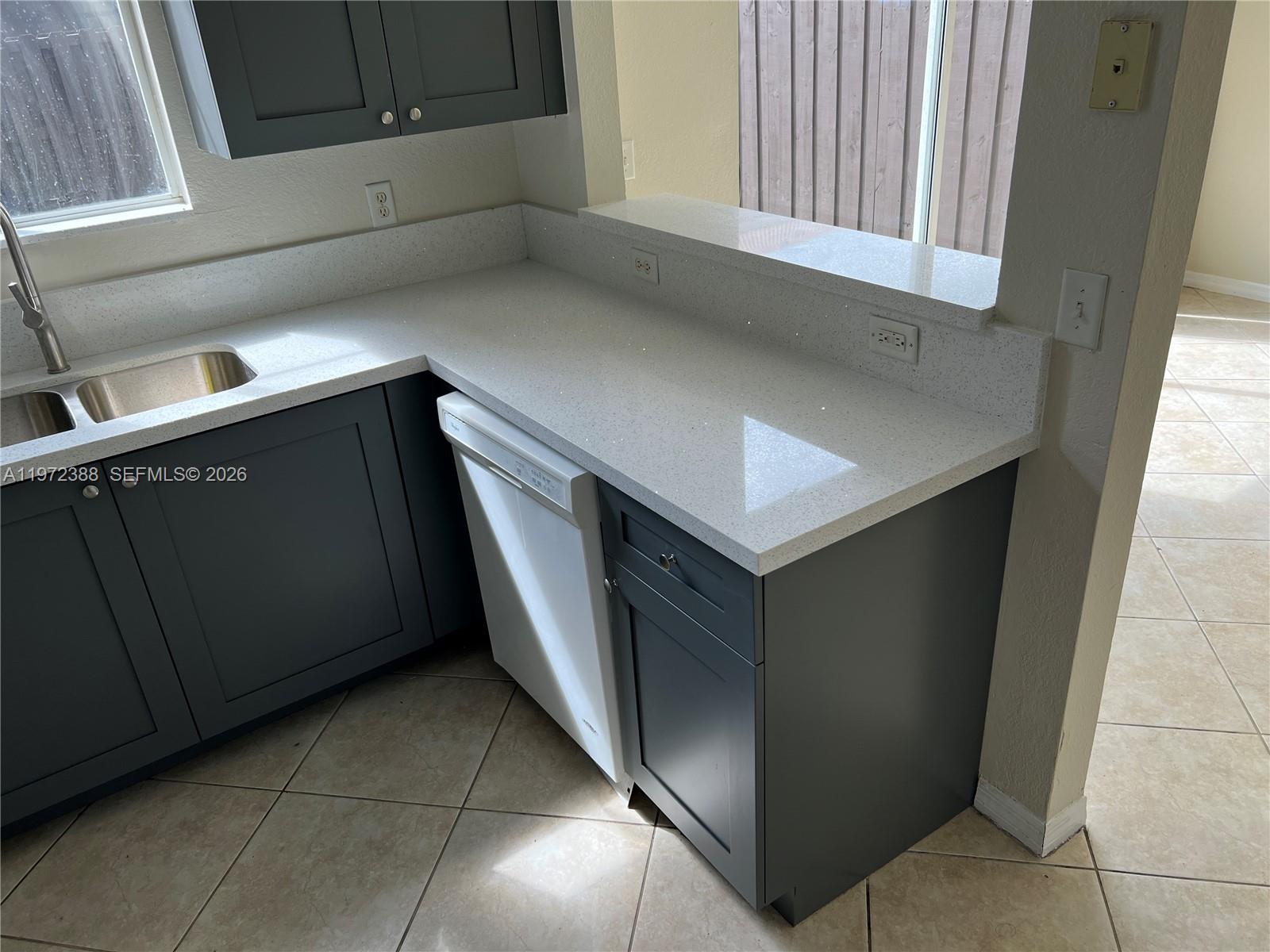 100 Southwest 15th Avenue Homestead, FL 33030 - Photo 15 of 62 a kitchen with a cabinets and a stove