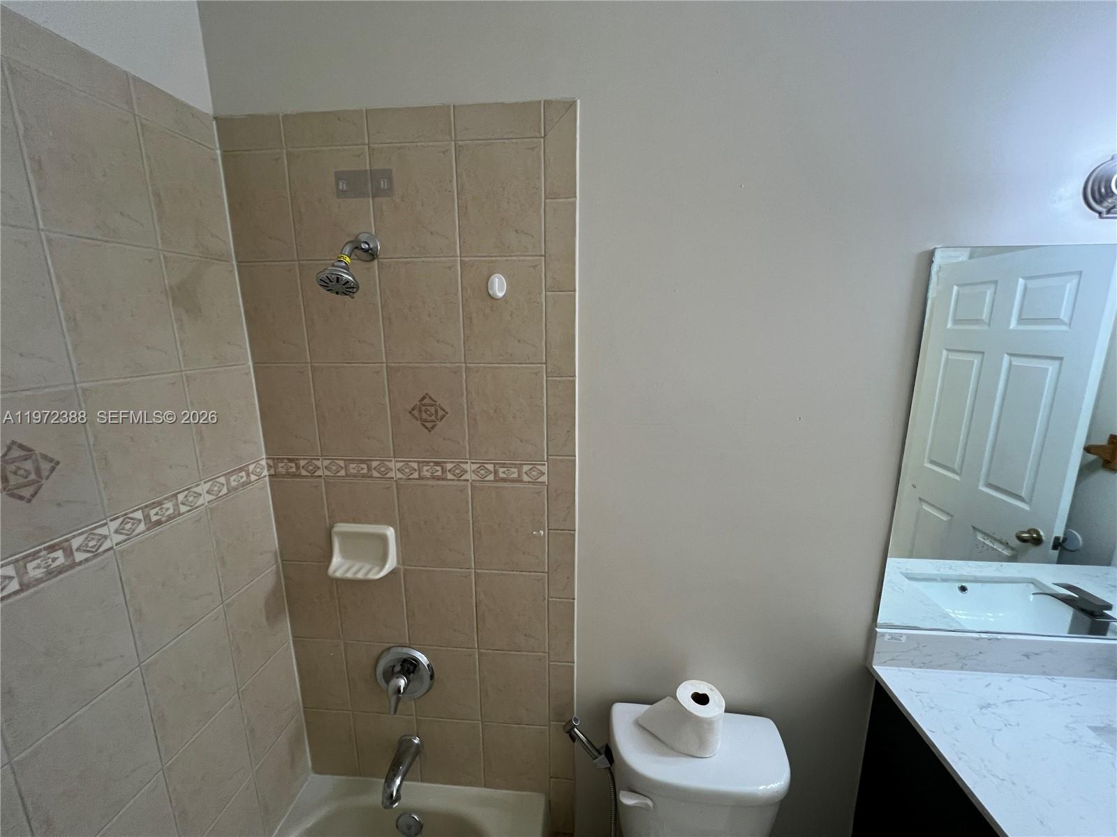 100 Southwest 15th Avenue Homestead, FL 33030 - Photo 22 of 62 a bathroom with a sink a mirror and a shower