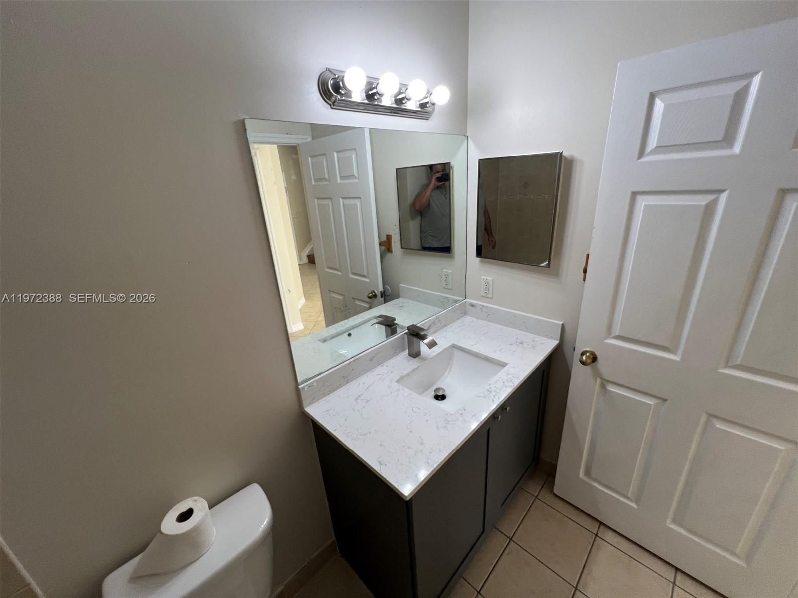 100 Southwest 15th Avenue Homestead, FL 33030 - Photo 23 of 62 a bathroom with a sink toilet and mirror
