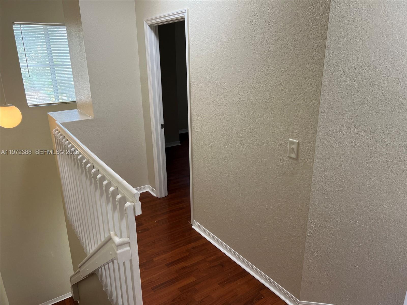 100 Southwest 15th Avenue Homestead, FL 33030 - Photo 28 of 62 a view of a hallway with wooden floor and staircase