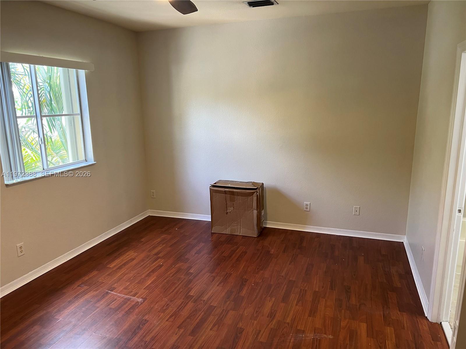 100 Southwest 15th Avenue Homestead, FL 33030 - Photo 29 of 62 an empty room with wooden floor and windows