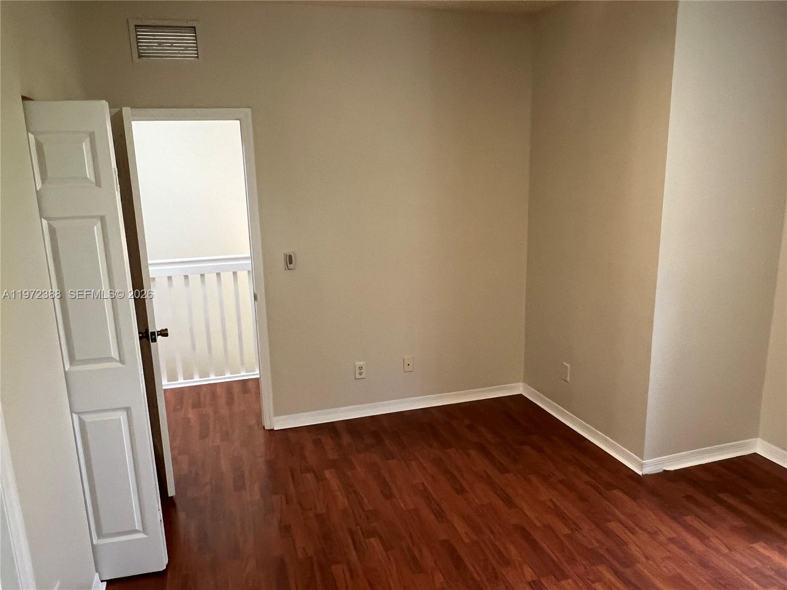 100 Southwest 15th Avenue Homestead, FL 33030 - Photo 31 of 62 an empty room with wooden floor and a window