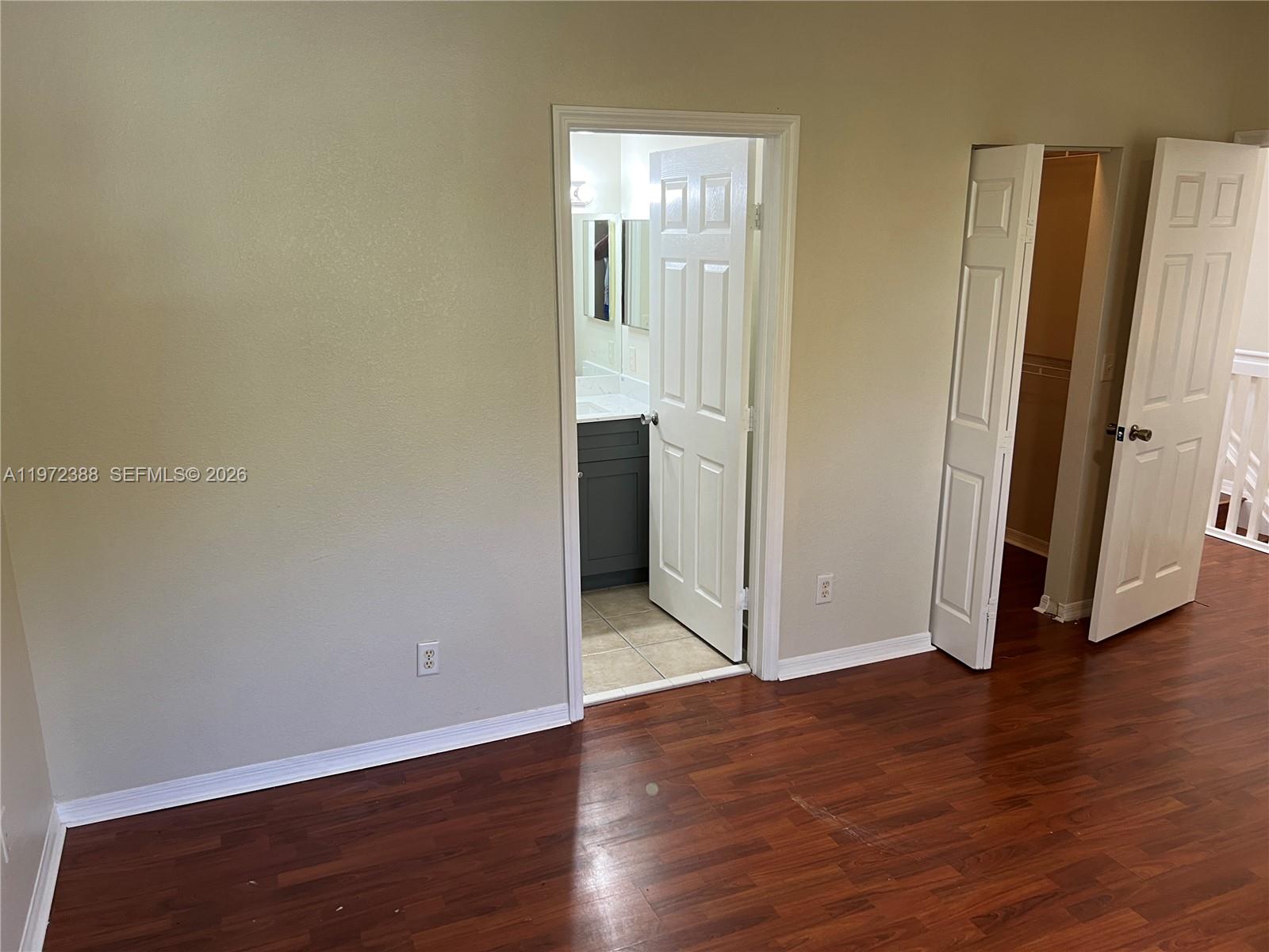 100 Southwest 15th Avenue Homestead, FL 33030 - Photo 34 of 62 an empty room with wooden floor and entrance