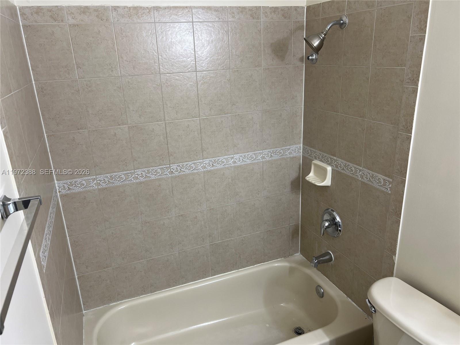 100 Southwest 15th Avenue Homestead, FL 33030 - Photo 38 of 62 a bath tub sitting next to a white toilet and a sink