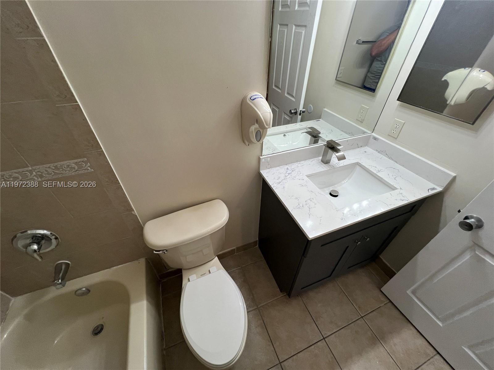 100 Southwest 15th Avenue Homestead, FL 33030 - Photo 39 of 62 a bathroom with a sink toilet and a mirror
