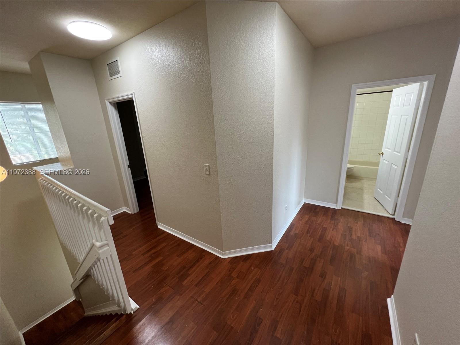 100 Southwest 15th Avenue Homestead, FL 33030 - Photo 42 of 62 a view of an empty room with wooden floor and stairs