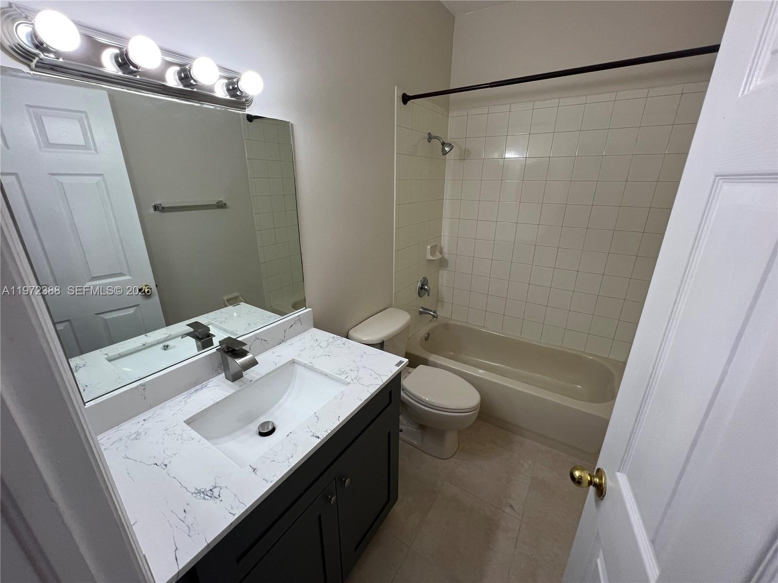 100 Southwest 15th Avenue Homestead, FL 33030 - Photo 48 of 62 a bathroom with a sink mirror toilet and shower