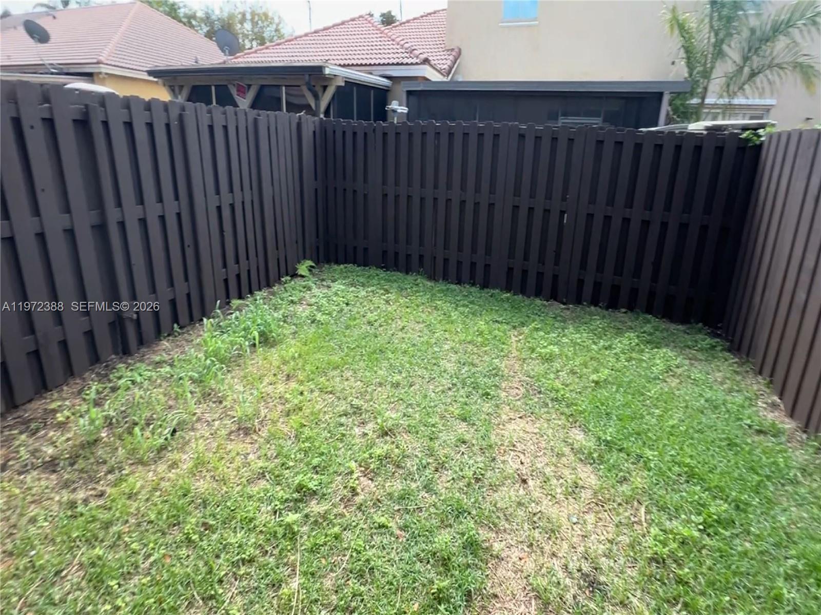 100 Southwest 15th Avenue Homestead, FL 33030 - Photo 58 of 62 a view of a backyard with wooden fence