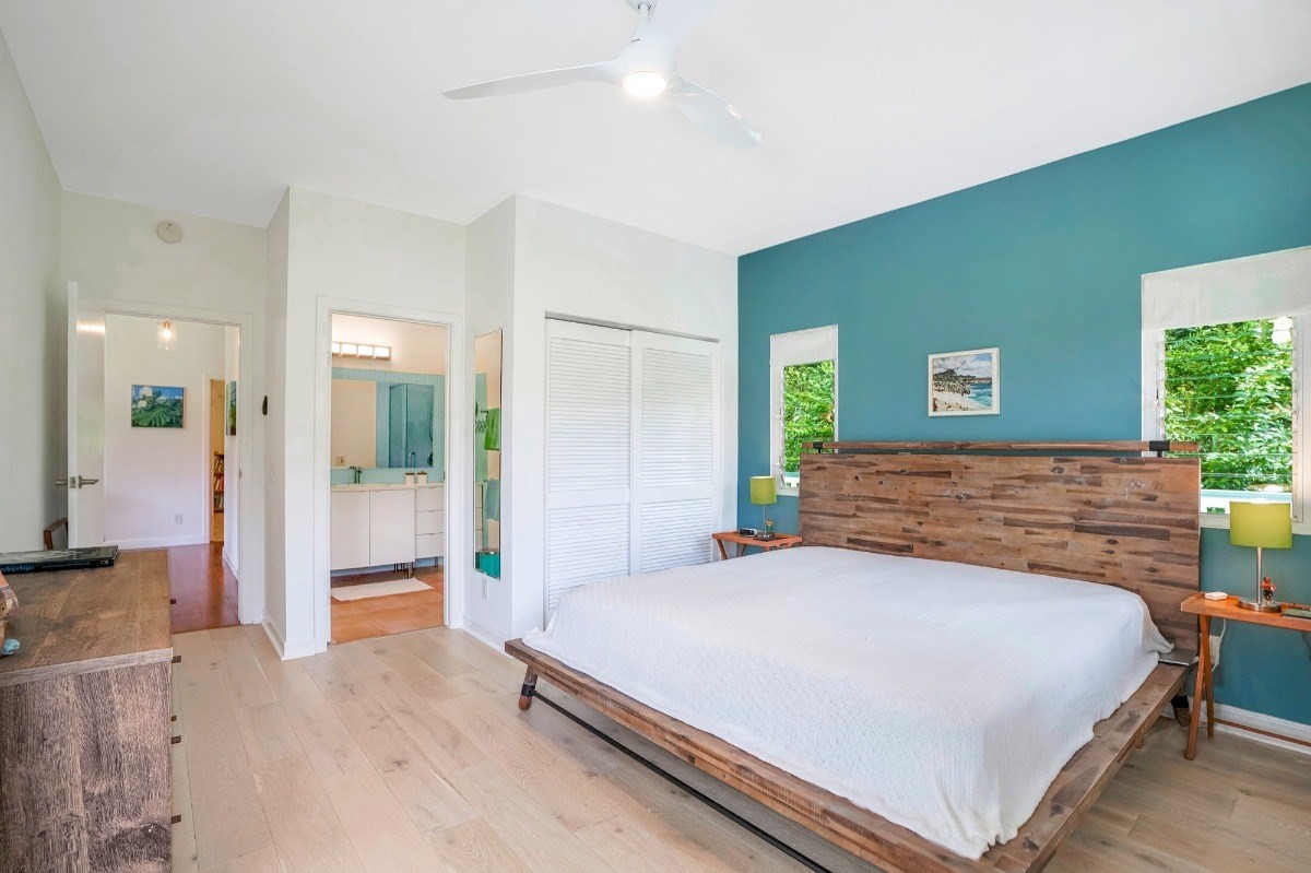 6431 Poo Road, Unit 2 Kapaa, HI 96746 - Photo 12 of 30 a bedroom with a large bed and a chandelier