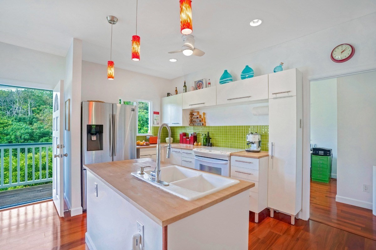 6431 Poo Road, Unit 2 Kapaa, HI 96746 - Photo 4 of 30 a kitchen with kitchen island stainless steel appliances a sink and wooden floor