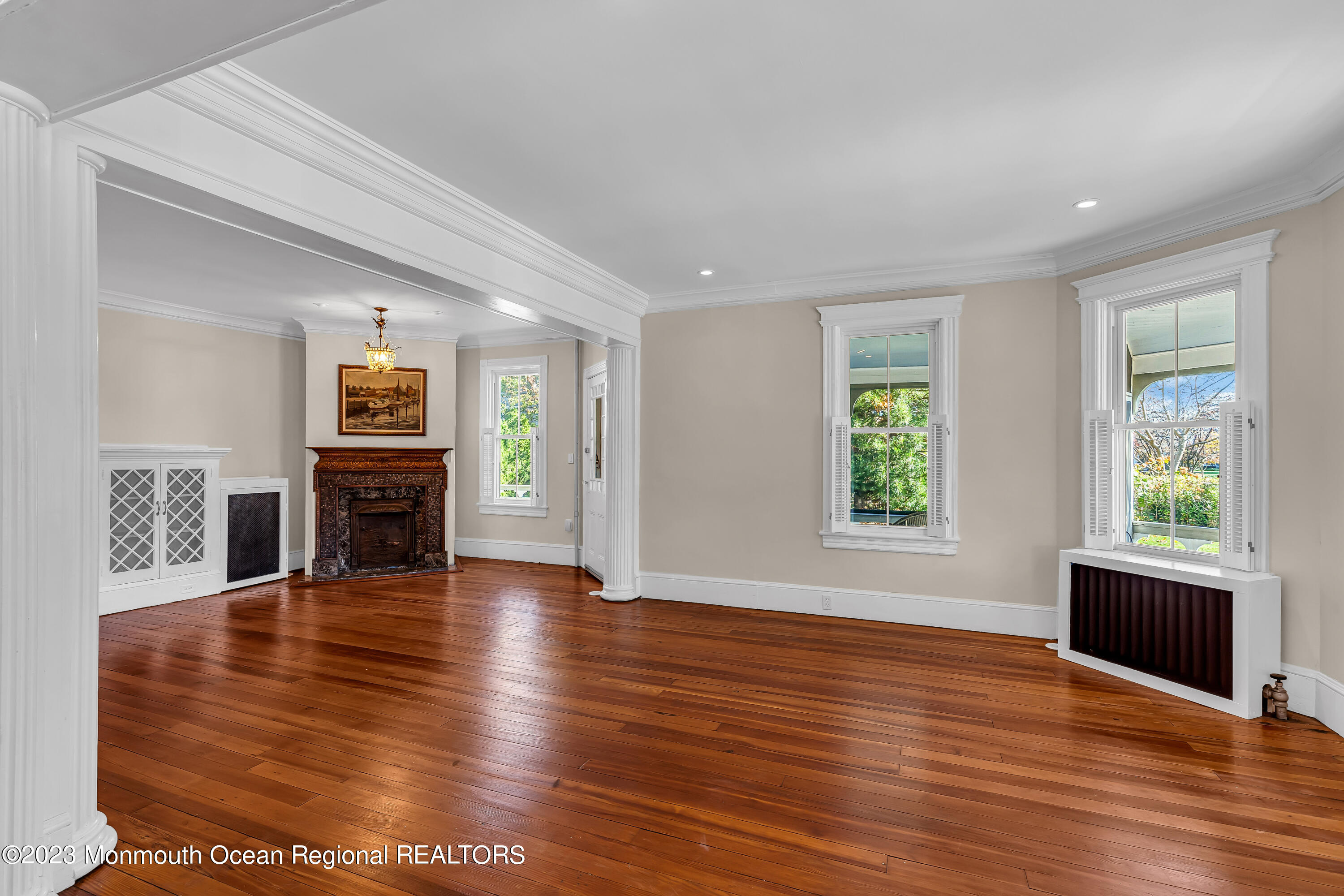 424 Mercer Avenue Spring Lake, NJ 07762 - Photo 12 of 36 an empty room with wooden floor and fireplace