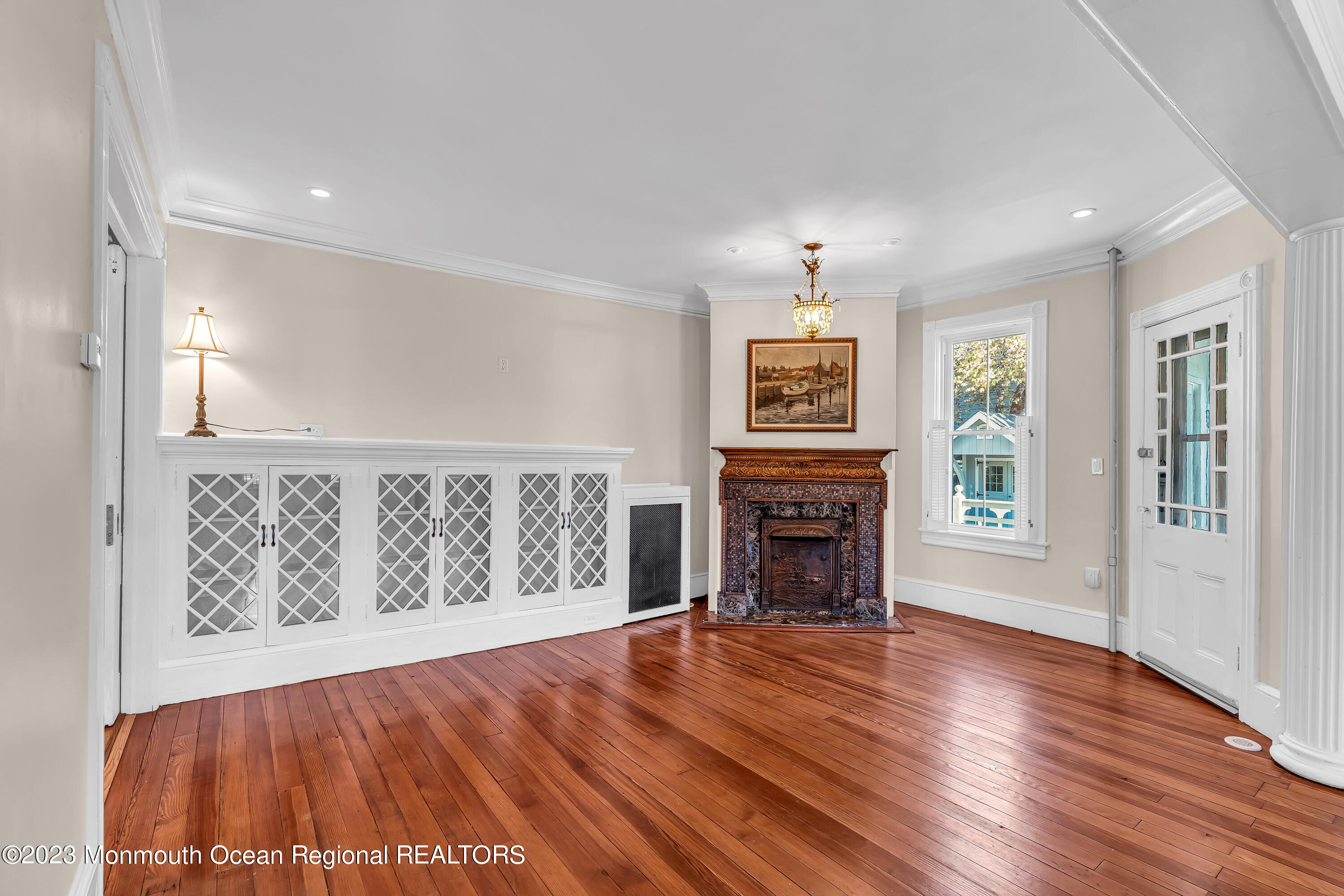 424 Mercer Avenue Spring Lake, NJ 07762 - Photo 16 of 36 an empty room with windows fireplace and wooden floor