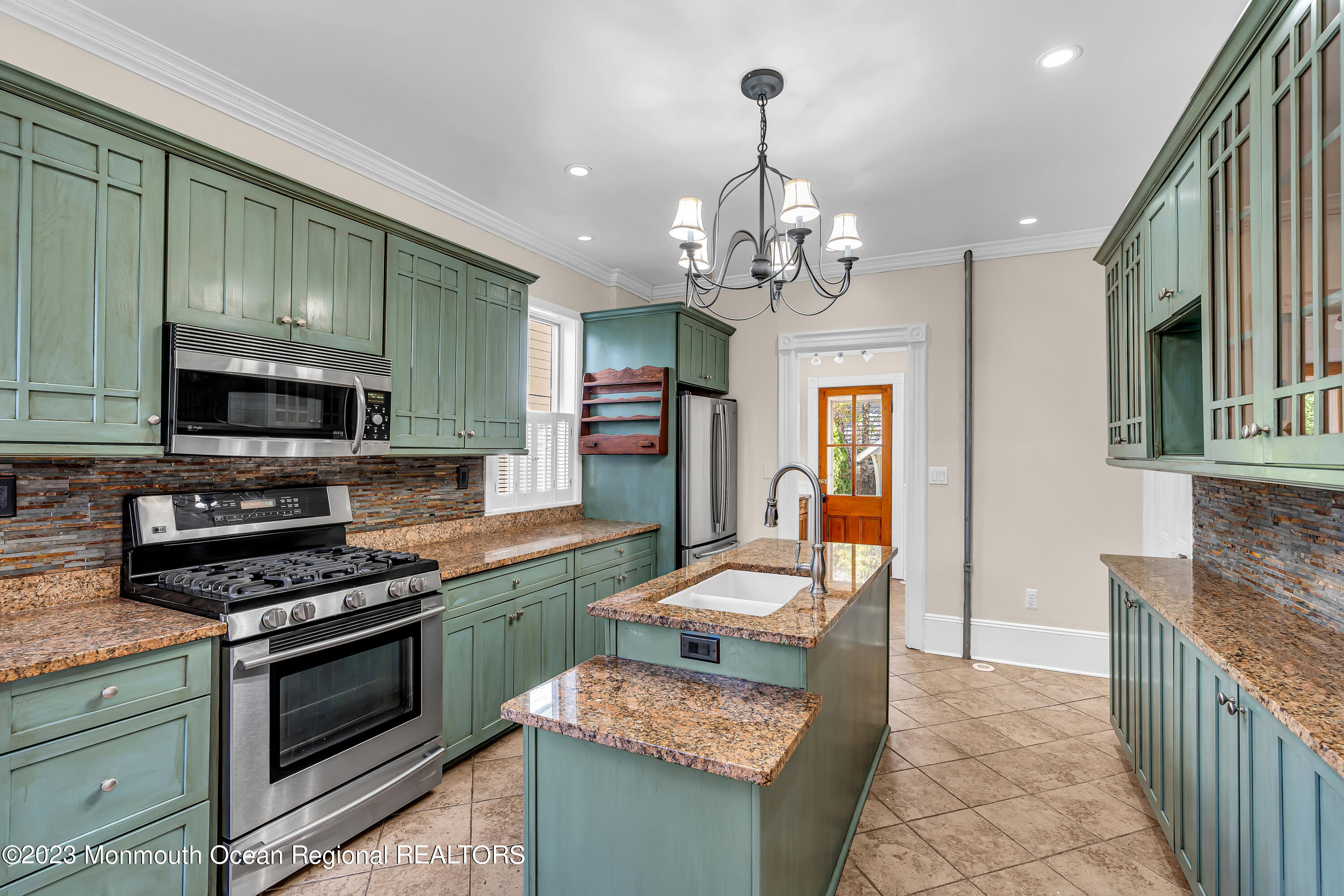 424 Mercer Avenue Spring Lake, NJ 07762 - Photo 24 of 36 a kitchen with stainless steel appliances granite countertop a stove top oven a sink dishwasher a microwave oven and a dining table with wooden floor
