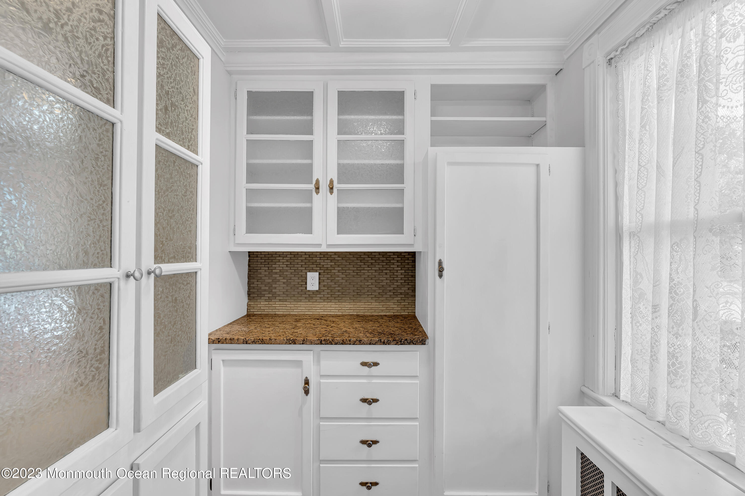 424 Mercer Avenue Spring Lake, NJ 07762 - Photo 25 of 36 a bathroom with granite countertop and white cabinets