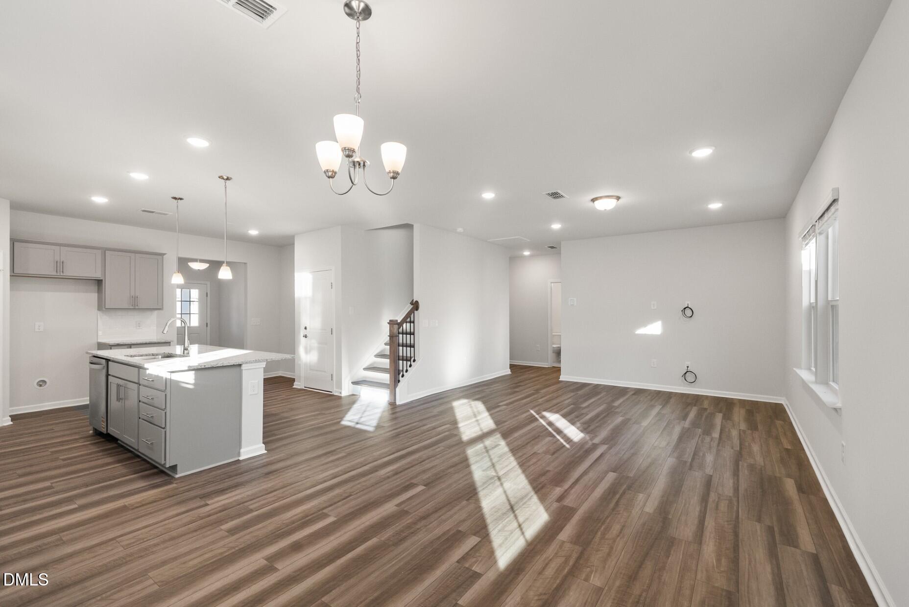 232 Bridle Brk Way Fuquay-Varina, NC 27526 - Photo 10 of 28 a view of a kitchen with a sink and dishwasher with wooden floor