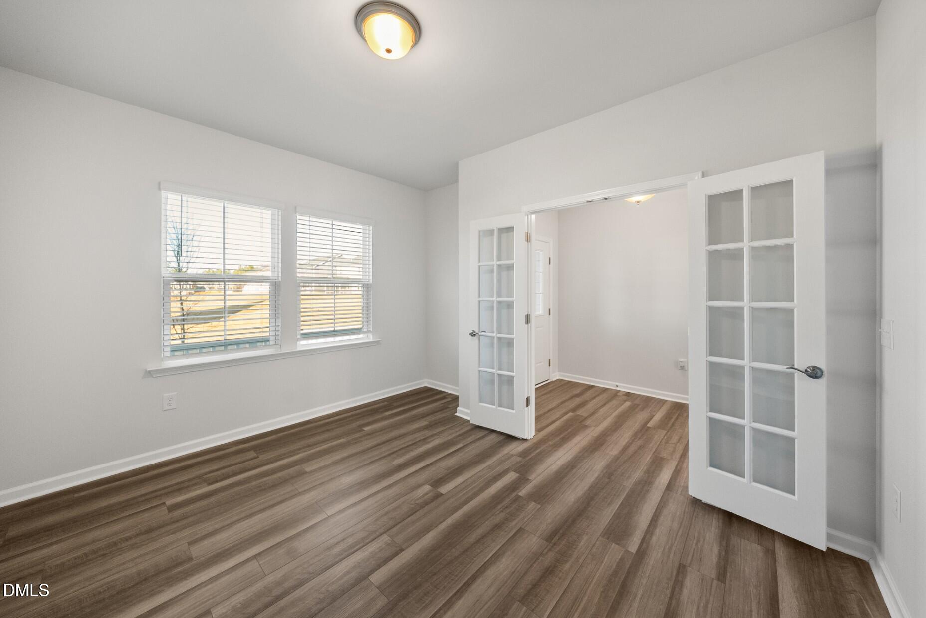 232 Bridle Brk Way Fuquay-Varina, NC 27526 - Photo 11 of 28 an empty room with wooden floor and windows