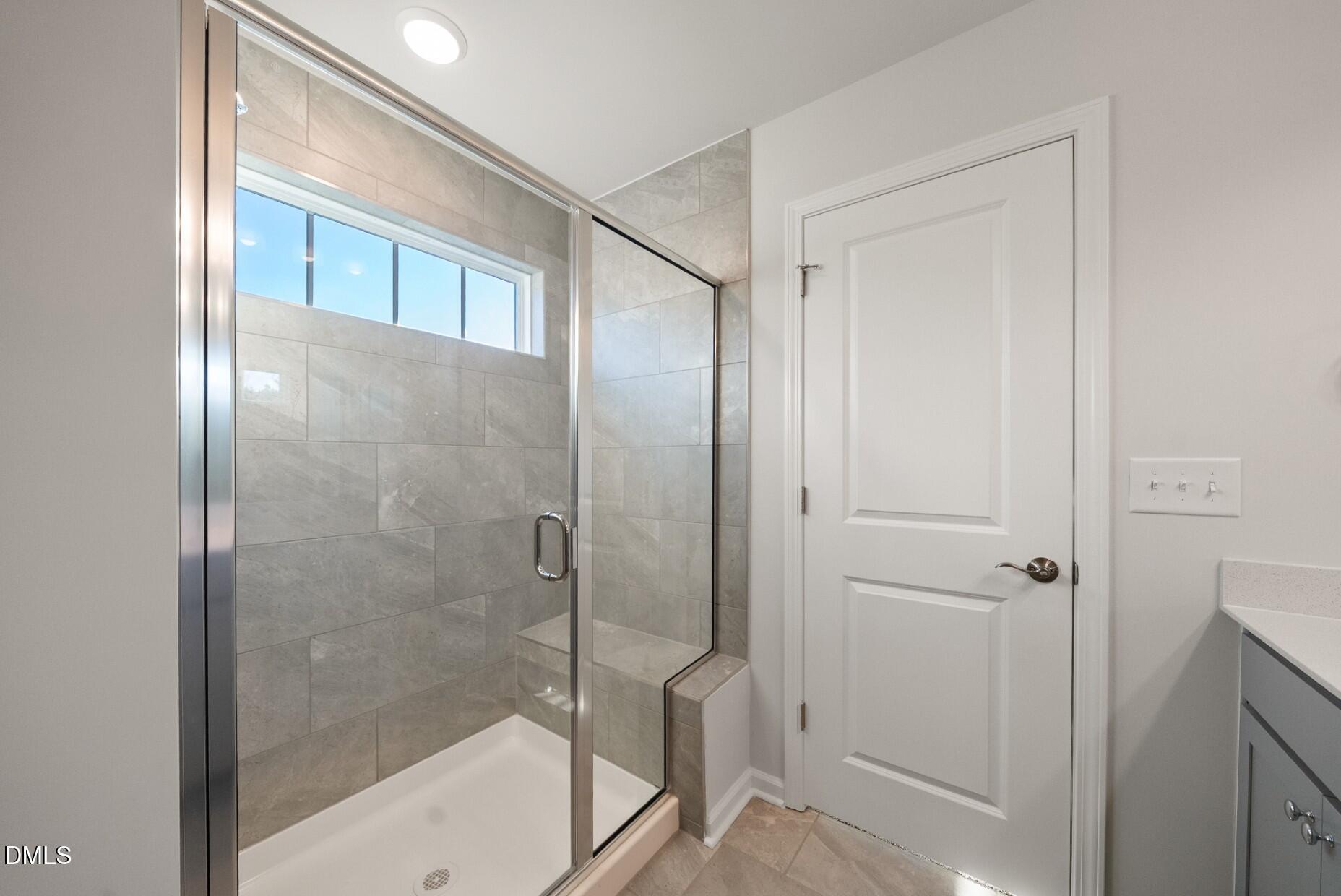 232 Bridle Brk Way Fuquay-Varina, NC 27526 - Photo 18 of 28 a bathroom with a glass shower door