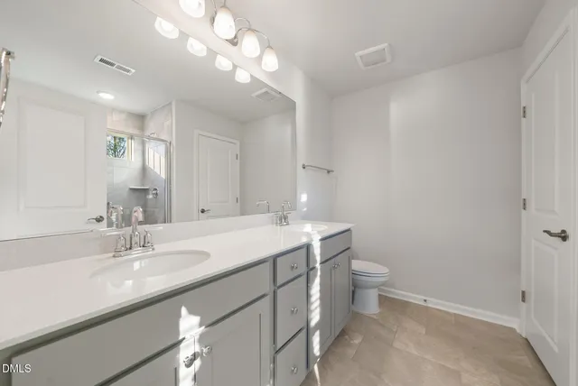 a bathroom with a glass shower door
