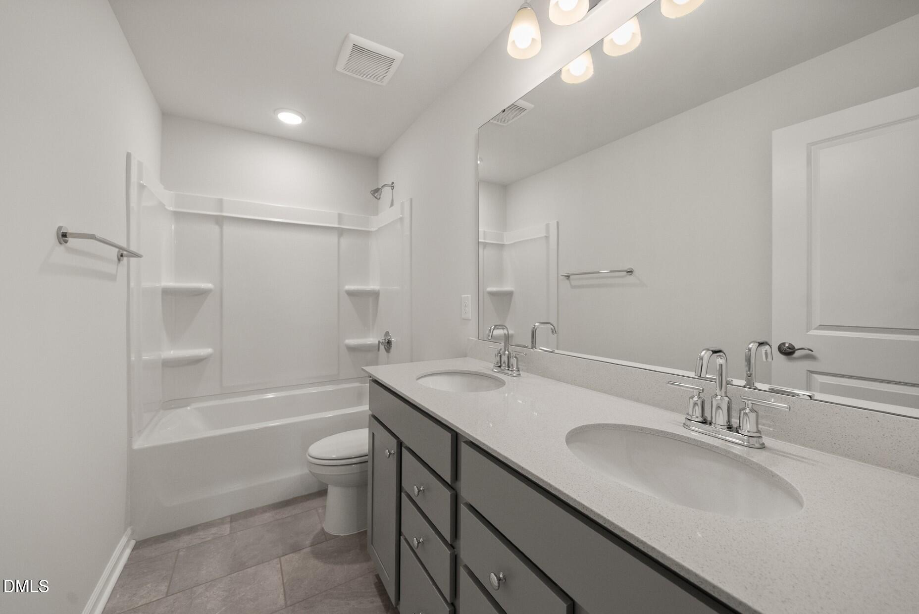 232 Bridle Brk Way Fuquay-Varina, NC 27526 - Photo 24 of 28 a bathroom with a granite countertop sink toilet and shower