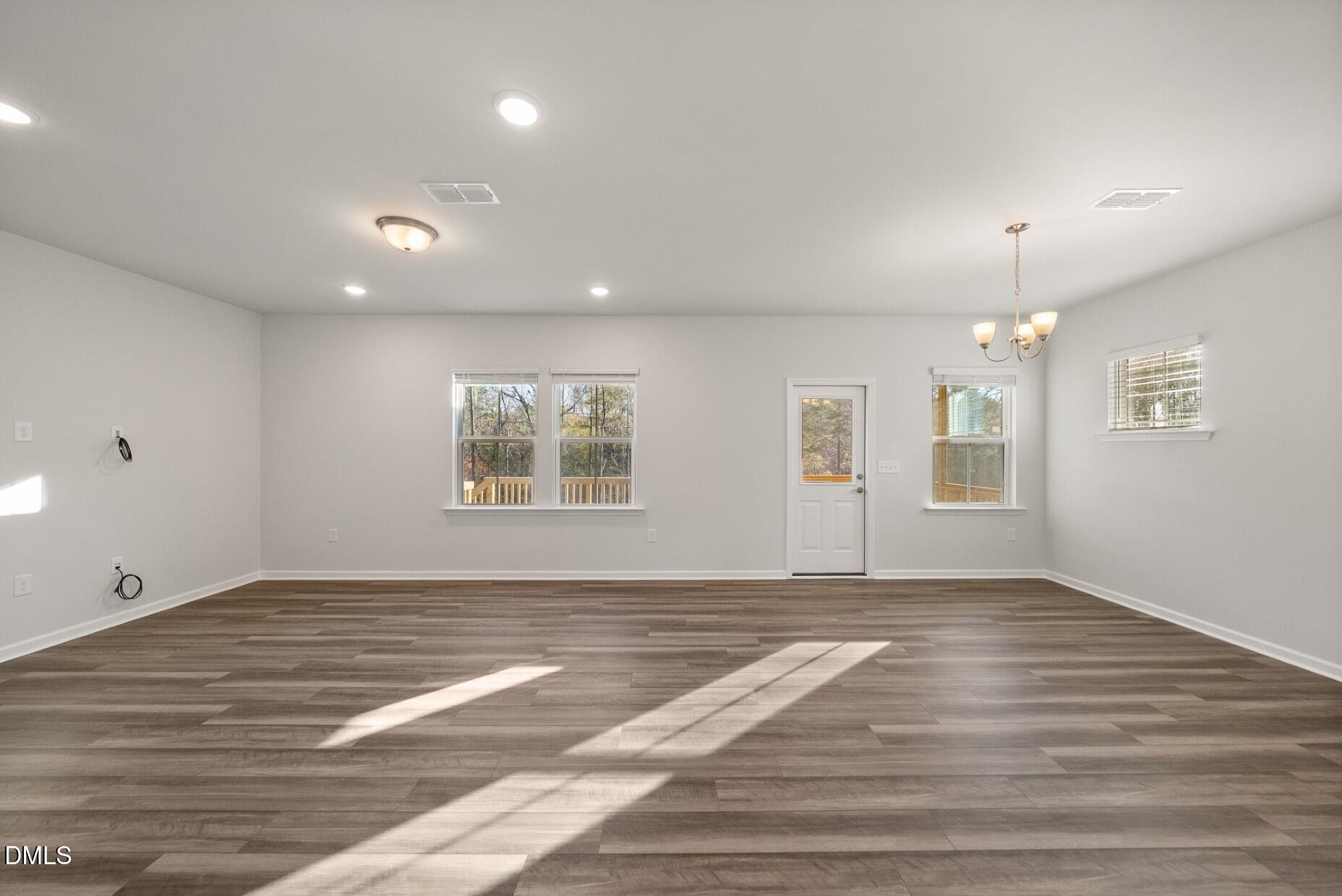 232 Bridle Brk Way Fuquay-Varina, NC 27526 - Photo 8 of 28 an empty room with wooden floor and windows