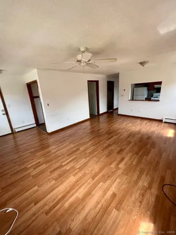 a view of a livingroom with a fireplace and wooden floor