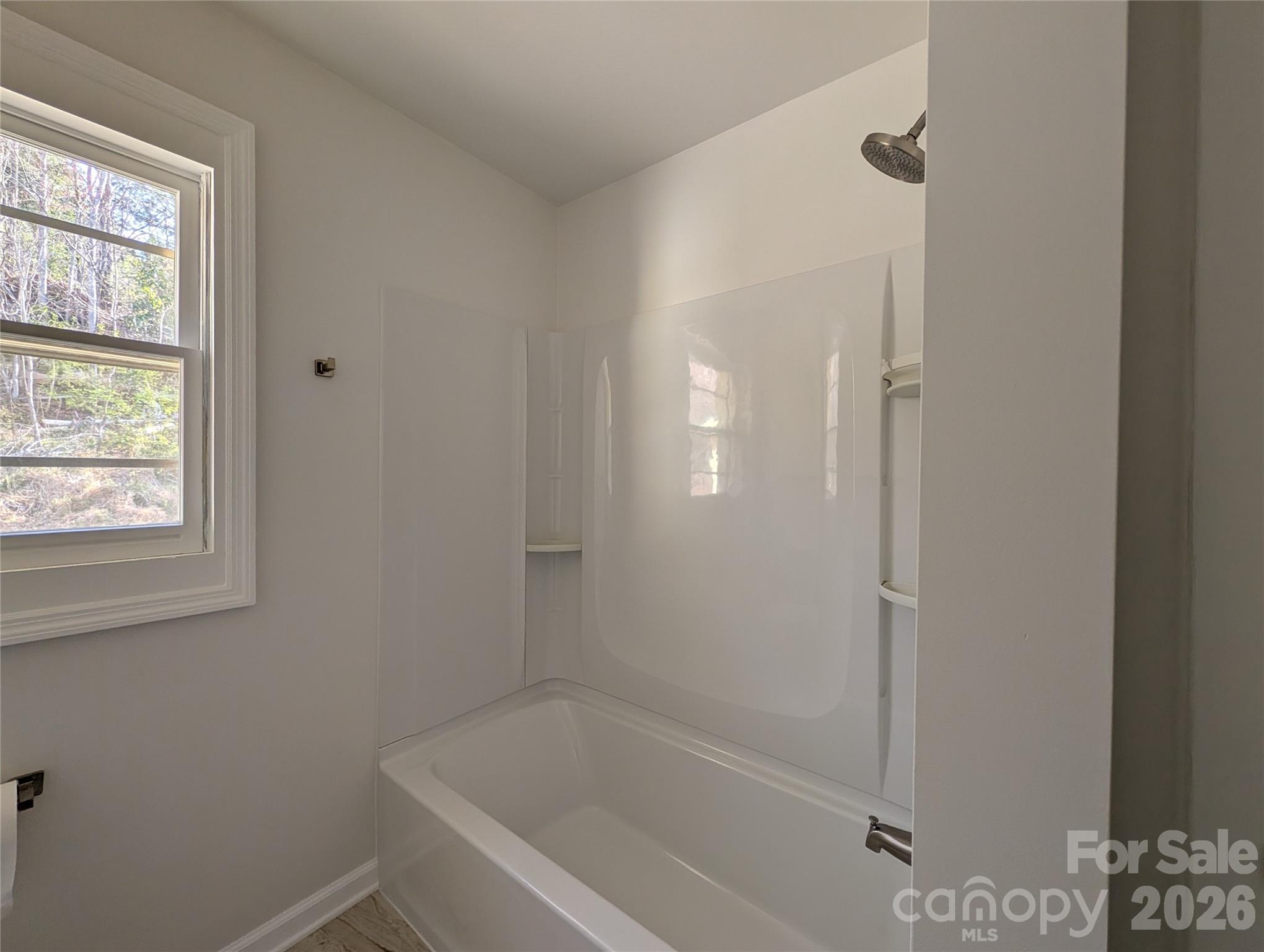 945 Summers Road Valdese, NC 28690 - Photo 12 of 25 a white bath tub sitting next to a window
