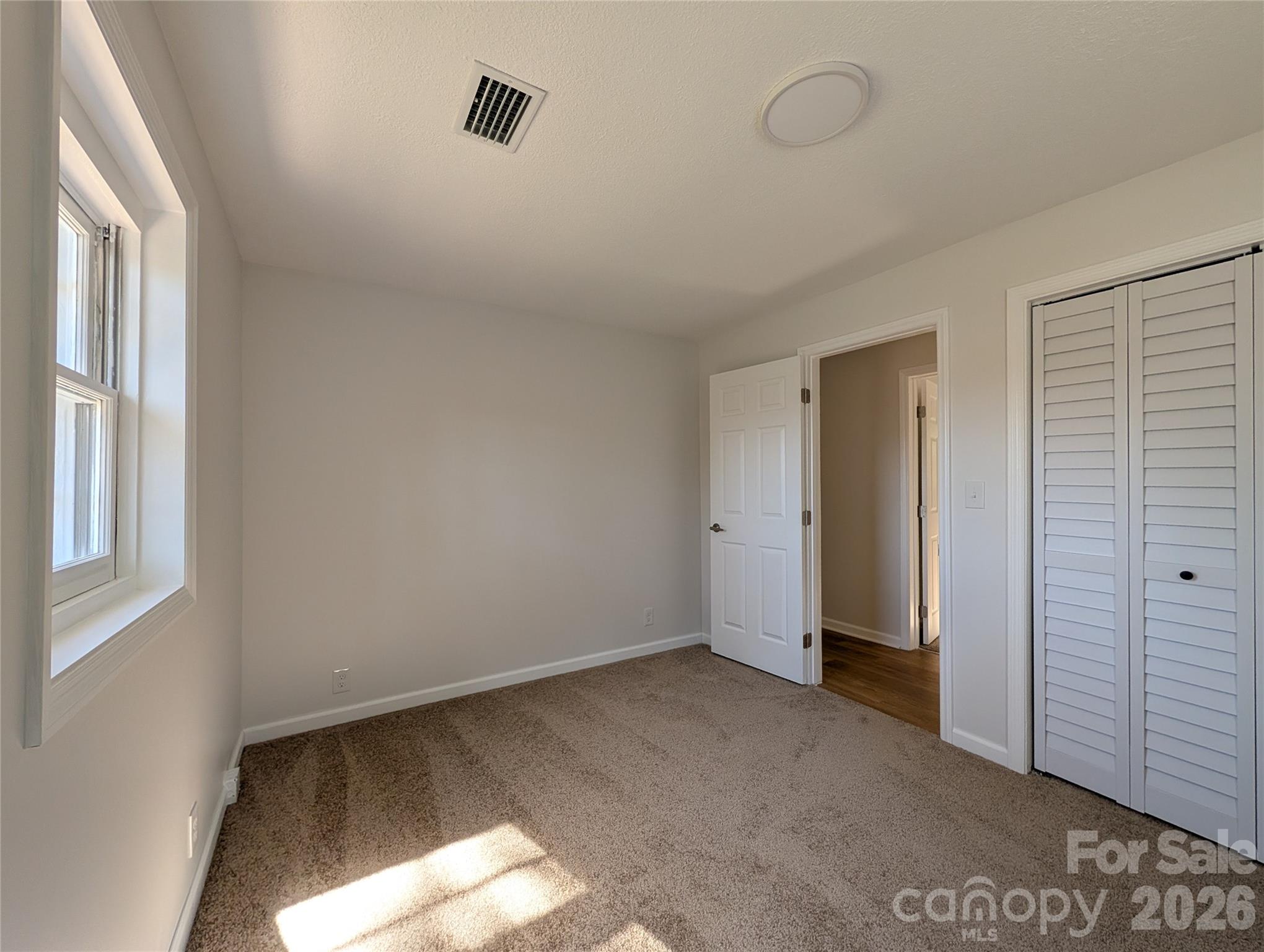 945 Summers Road Valdese, NC 28690 - Photo 18 of 25 a view of an empty room with a window